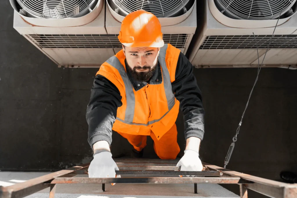 HVAC technician servicing rooftop air conditioning units