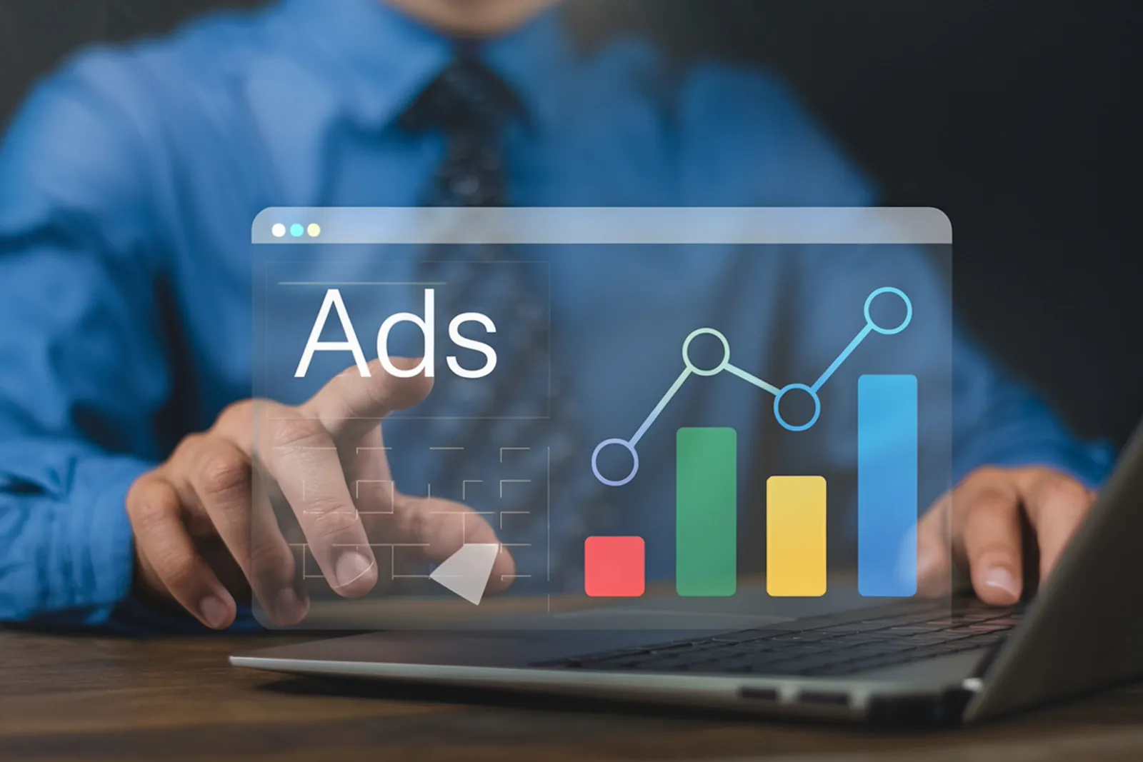 Person reviewing an advertising performance chart above a laptop